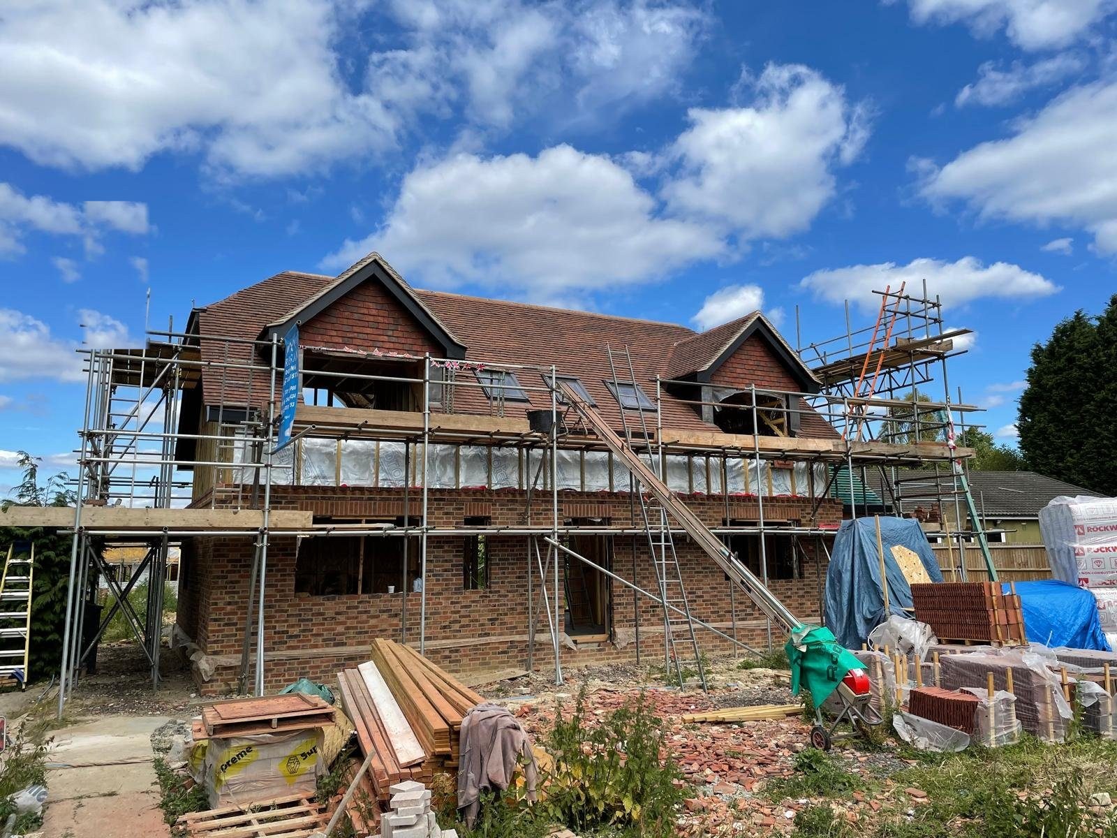 A brick new-build home taking shape on an I.C Developments site in Surrey