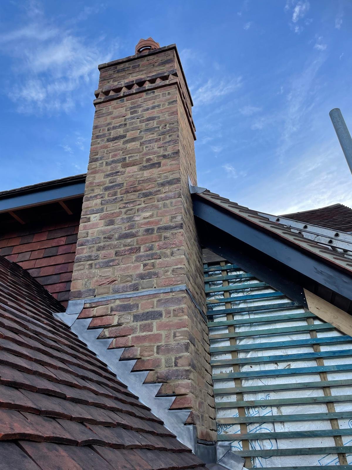 A new-build brick semi-detached home in Surrey under a clear sky
