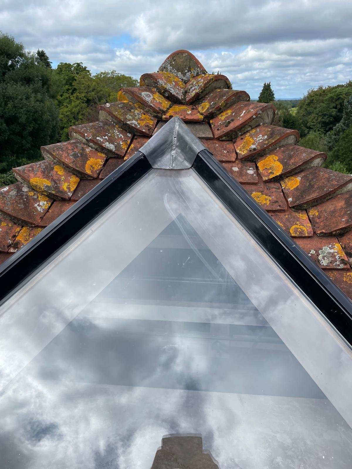 A glazed roof lantern set into a tiled roof, bringing daylight into the room below